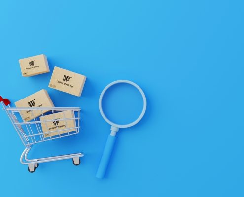 Online shopping concept. Web or mobile application ecommerce. Top view of carton paper box with shopping cart and magnifying glass on blue background. 3d rendering